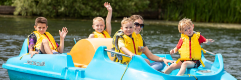 Family enjoying the lake in a small boat